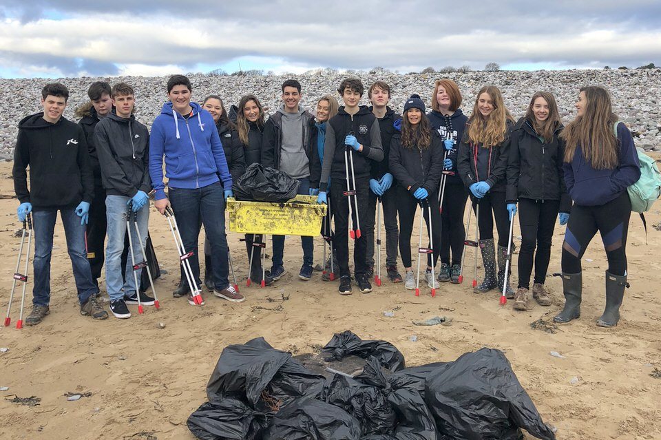 Students from St Clare's independent private school on Newton Beach with the rubbish they have collected